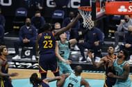 LaMelo Ball #2 of the Charlotte Hornets attempts a lay up against Draymond Green #23 of the Golden State Warriors.
